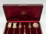 an antique silverware set in a case with a red velvet lining