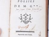 someone is holding an old book with writing on it in their hand