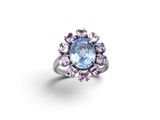 a close up of a ring with a blue topaz and pink topaz