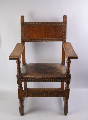 a wooden chair with a brown leather seat on a white background