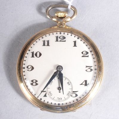 a close up of a pocket watch on a white surface