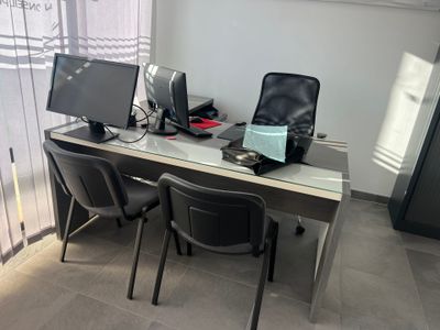a desk with two computer monitors and a laptop on it