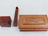 a wooden box with a butterfly on it next to a wooden box