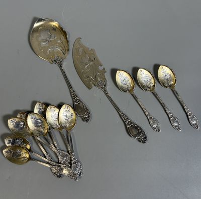 several silver spoons and spoon spoons sitting on top of a table