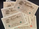 five old german bank notes on a black surface