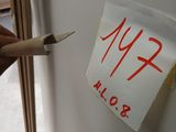 a person holding a pen and writing on a piece of paper