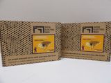 two boxes of electronic boxes sitting on a table