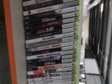 a stack of dvd ' s sitting on a shelf next to a window