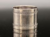 a close up of a silver ring on a black surface