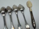five spoons and two spoons sitting next to each other