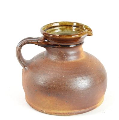 a brown vase with a brown handle on a white background
