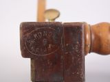 a wooden handle that has a stamp on it