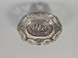 a silver plate with a picture of a man and a woman on it