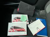 a lot of items that are sitting on the seat of a car