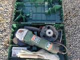 a green box with tools in it sitting on the ground