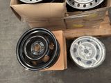a box of rims and a box of tires on the ground