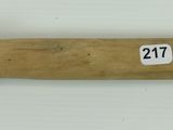 a close up of a wooden handle with a number on it