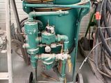 a green cart with a bunch of hoses on top of it
