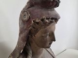 a statue of a woman with a bird on her head