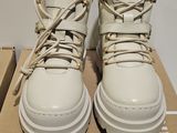 a pair of white shoes that are on a box