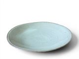a white plate with a blue rim on a white surface