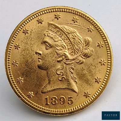 gros plan d'une pièce d'or portant un visage de femme