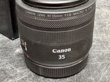 the canon 35mm f / 1 8 macro lens is sitting on a table next to a box