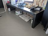 a desk with a laptop on it in the corner of a room