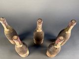 three bottles of wine that are sitting on a table