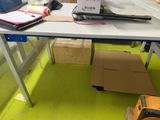 a table with a laptop on it and a box on the floor