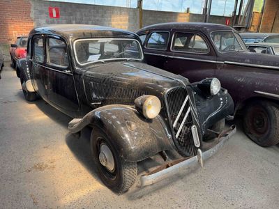 two old cars parked next to each other in a parking lot