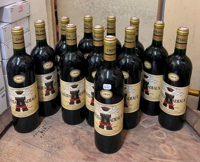 many bottles of wine sitting on a wooden table