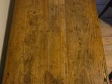 a wooden table with a wooden top on the floor