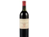 a bottle of red wine sitting on a white surface