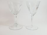 two wine glasses sitting next to each other on a table