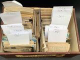 a box full of old books with papers in it