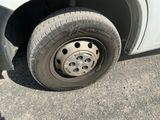 a tire on the side of a car with a flat tire
