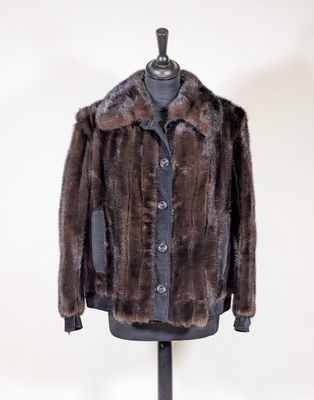 a close up of a fur coat on a mannequin stand