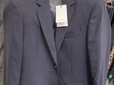a suit on a hanger in a clothing store