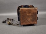 a small metal box with a cord attached to it
