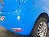 a blue car that is parked in a garage
