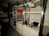 a room with shelves and a laptop computer on it