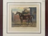 framed print of a horse in a stable by a brick wall