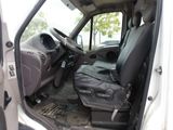 a white van with a black seat and a black bag in the back