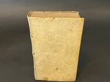 an old book sitting on top of a table next to a black background