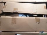 a cat that is sitting on top of a cardboard box