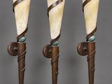 a set of three art deco sconces in the form of a torch