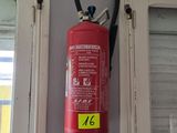 a red fire extinguisor hanging on the wall
