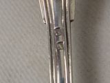 a silver spoon with a handle on a table