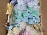 a cardboard box filled with lots of different colored candies